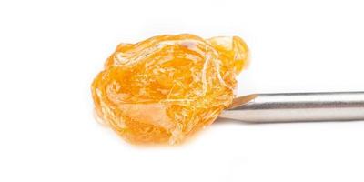 a piece of concentrated cannabis wax , high thc dab photo