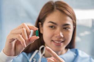 woman hand holding a pills take medicine according to the doctor's order photo