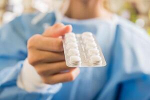 Woman pharmacist holding prescription medicine from doctor order photo