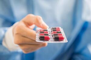 Woman pharmacist holding prescription medicine from doctor order photo