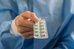 Woman pharmacist holding prescription medicine from doctor order photo