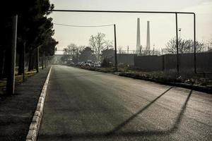 Road view with a gas pipeline and factory pipes. photo