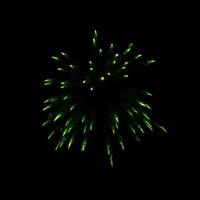 green fireworks burst in the air light up the sky with dazzling display and Colorful fireworks festivals on black. photo