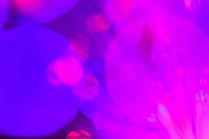 light purple neon light abstract Neon bright lens flare colored on black background.dark abstract futuristic background and Neon photo