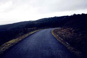 dark road beautiful Road and ways in the hills and Mountain road grassland road in the evening. photo