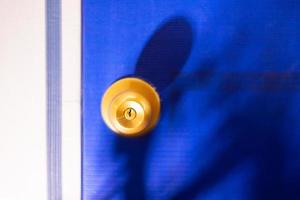 Gold lock on blue door photo