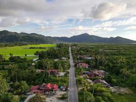 Aerial view asphalt road and rural Malays Kampung house photo