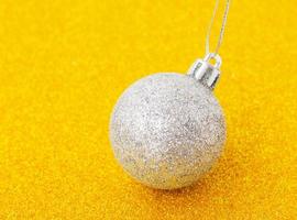 white christmas balls on glittering gold background photo