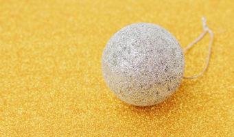 white christmas balls on glittering gold background photo