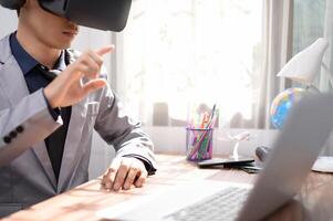 Businessman is using VR glasses to work. Virtual world. photo