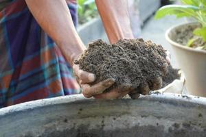 farmer hand hold soil close up photo