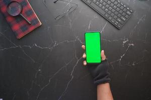 hacker hand stealing data from smart phone photo