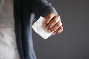 drug addiction concept with hand holding heroine packet on black backgrund photo