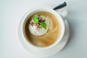 una taza de café tardío con helado en la mesa foto