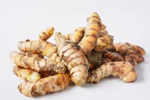detail shot of turmeric root in white background photo