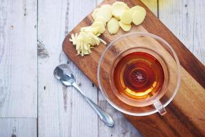 Top view of ginger tea on wooden background. photo