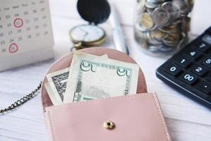 us dollar cash in leather on pink background photo