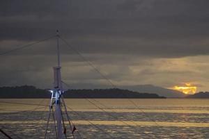 Sunset background with ships silhouette photo