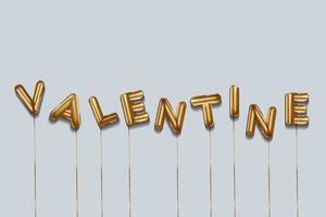valentine written with foil gold balloons. valentine lettering with realistic gold balloons. valentine typography. isolated vector design. valentine background with copy space area