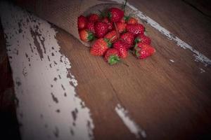 Strawberry on old wooden background, love and valentine theme photo