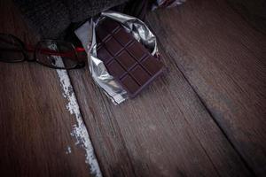 Valentine dark chocolate on old wooden background photo