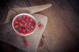 Strawberry on old wooden background, love and valentine theme photo