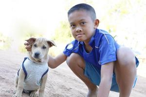 An Asian boy and his little Thai dog. photo