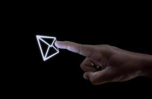 Human hand touching the e-mail button, Concepts of communication technology. photo