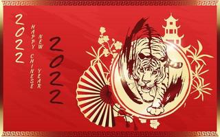 Tiger with gold on the red background of a Chinese pagoda, bamboo, sakura and a fan. Happy Chinese New Year 2022. Year 2022 symbol with text.