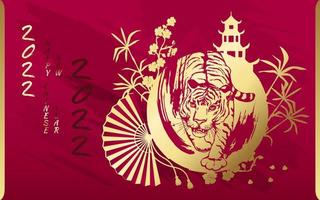 Tiger with gold on the background of a Chinese pagoda, bamboo, sakura and a fan. Happy Chinese New Year 2022. Year 2022 symbol with text.