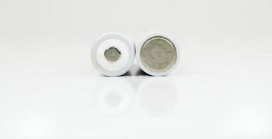 Two alkaline batteries on a white background with reflection. Energy supply and recycling concept. Copy space. Minimalism. Eliment AA is the most common type of galvanic batteries and accumulators. photo