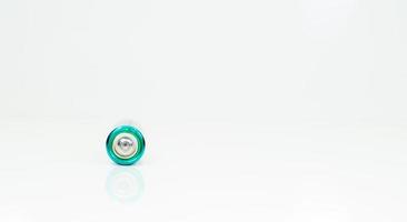 One alkaline battery on a white background with reflection. Energy supply and recycling concept. Copy space. Minimalism. Eliment AA is the most common type of galvanic batteries and accumulators. photo