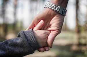 hand holds baby hand photo