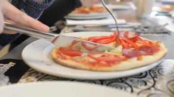 Children make and eat a pizza with his own hands in the restaurant video