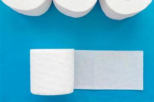 Rolls of white toilet paper on a blue background. Close up. The view from the top. photo