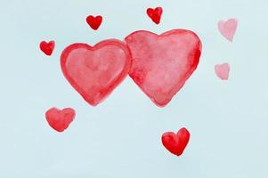Drawing of a child red hearts in watercolor on a white sheet. photo