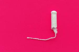 women's tampons on a red background with a place for writing. The concept of women's health. photo