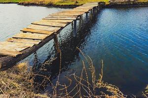 wooden bridge over the river photo