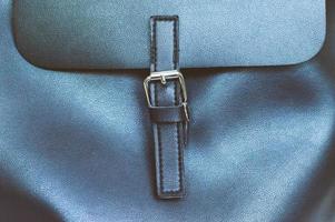 clasp on women's bag, black clasp in the form of a belt on a fashionable black backpack photo