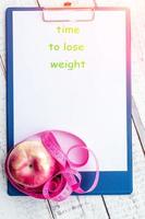 centimeter tape, Apple, Notepad with space for text. the concept of health, weight loss, diet, colony burning, overweight. minimalism, the view from the top. photo