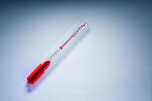 Medical laboratory. A test tube with blood on a white background. The concept of laboratory research. photo