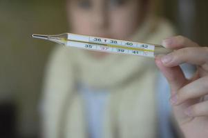 little girl with fever and sneezes photo