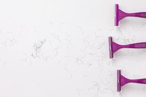 Purple shaving machine on a white background. The concept of hygiene. Place for the label. photo