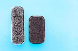 Shoe cleaning sponges on a blue background with a place for writing . Close up. photo