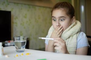 little girl with fever and sneezes photo