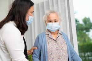 Ayude y cuide a una anciana asiática mayor o anciana que use un andador con una salud fuerte mientras camina en el hospital. foto