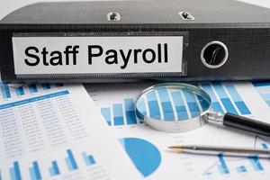 Staff Payroll. Binder data finance report business with graph analysis in office. photo