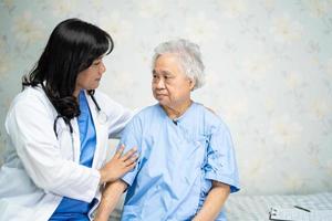 Touching  Asian senior or elderly old lady woman patient with love, care, helping, encourage and empathy at nursing hospital ward, healthy strong medical concept photo