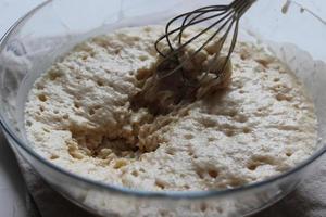 Batter with a whisk in a large glass bowl. Homemade cake. Concept of homework during the quarantine period. photo
