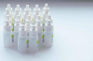 group of nose drop jars on a white background. The concept of dependence on Nosal drops. Illness, cold. photo